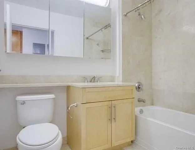 a bathroom with a sink a toilet and bathtub