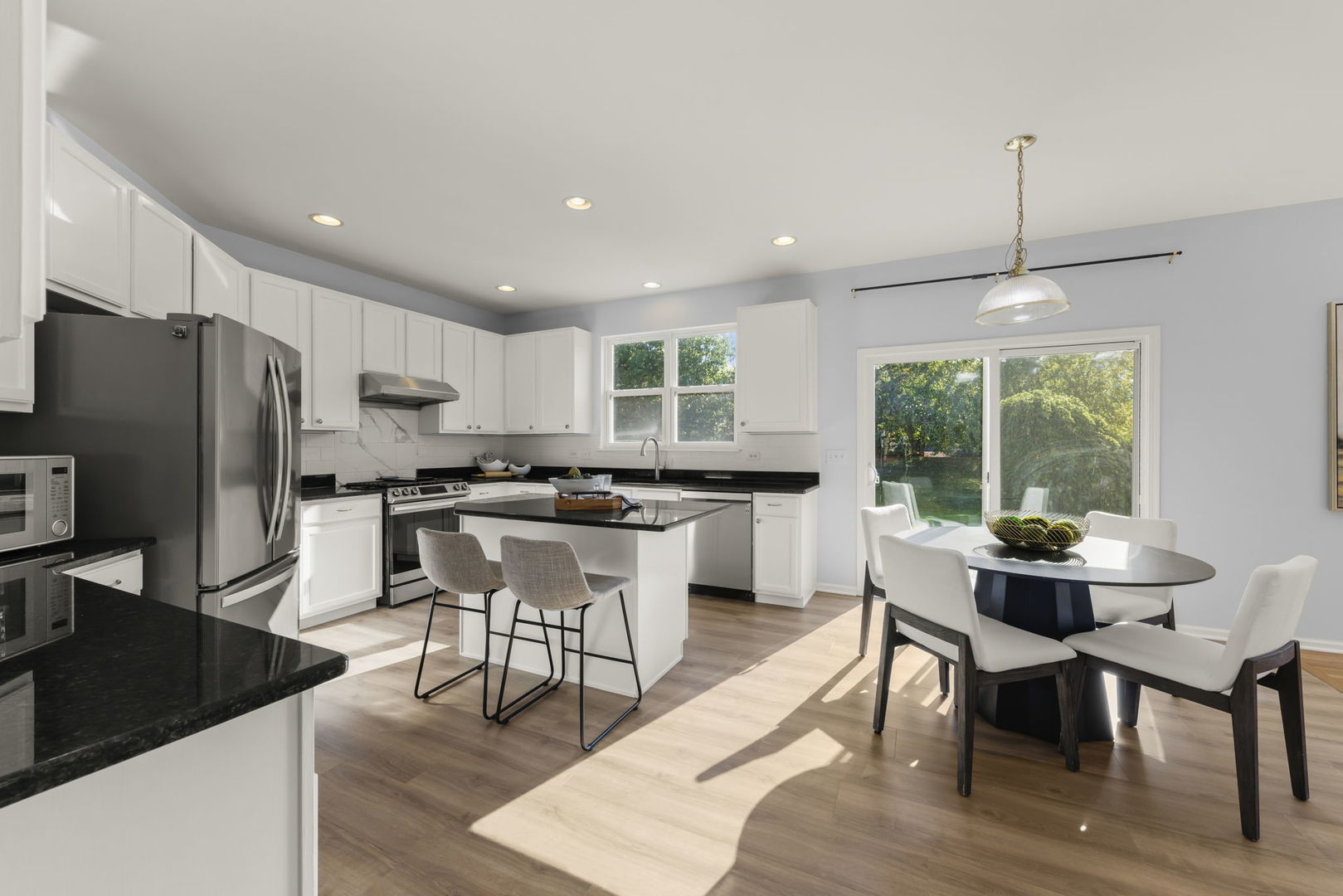 5 Player Court Bolingbrook, IL 60490 - Photo 6 of 37 a kitchen with a dining table chairs refrigerator and cabinets