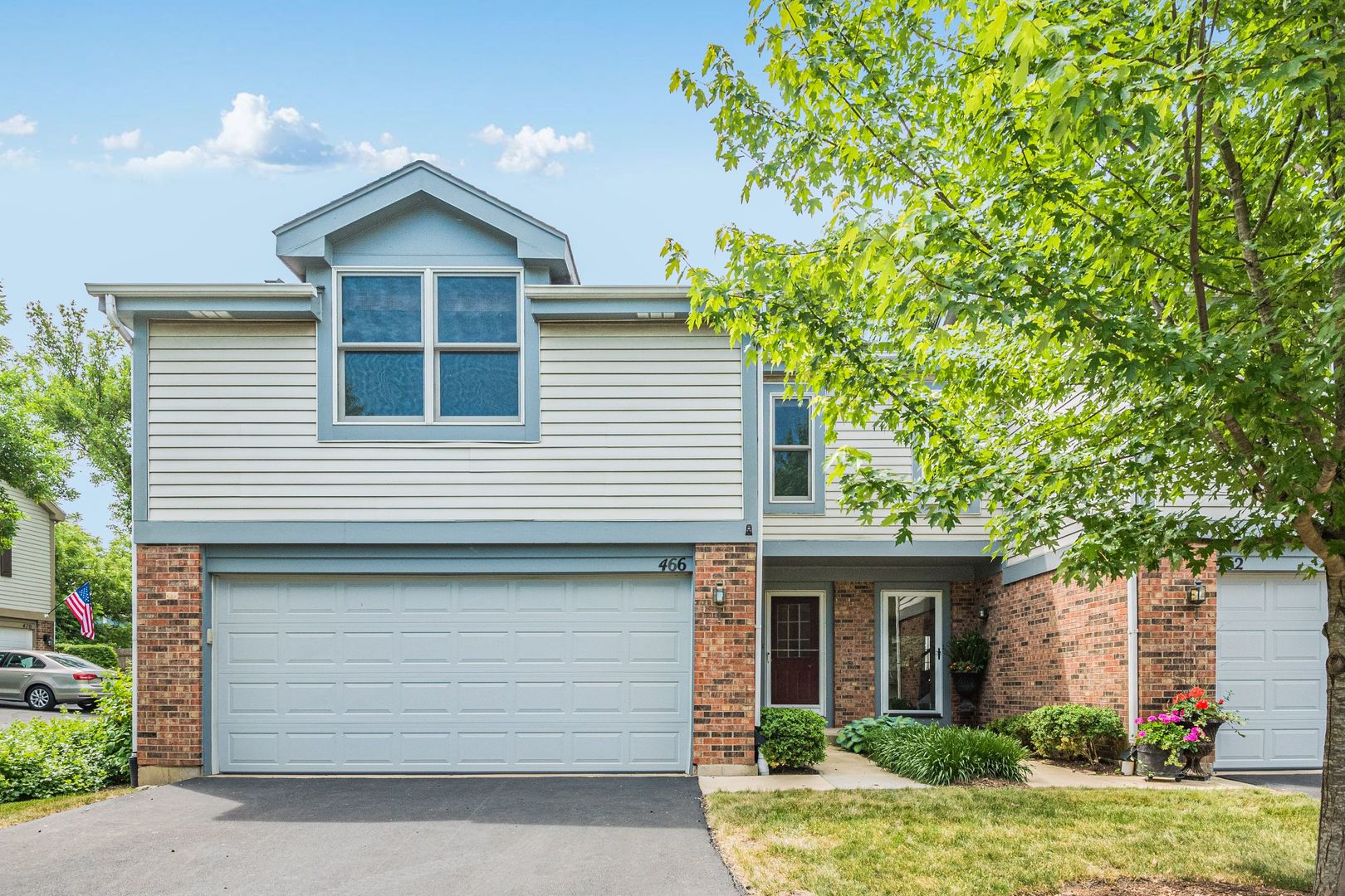 a front view of a house with a yard garage and outdoor seating