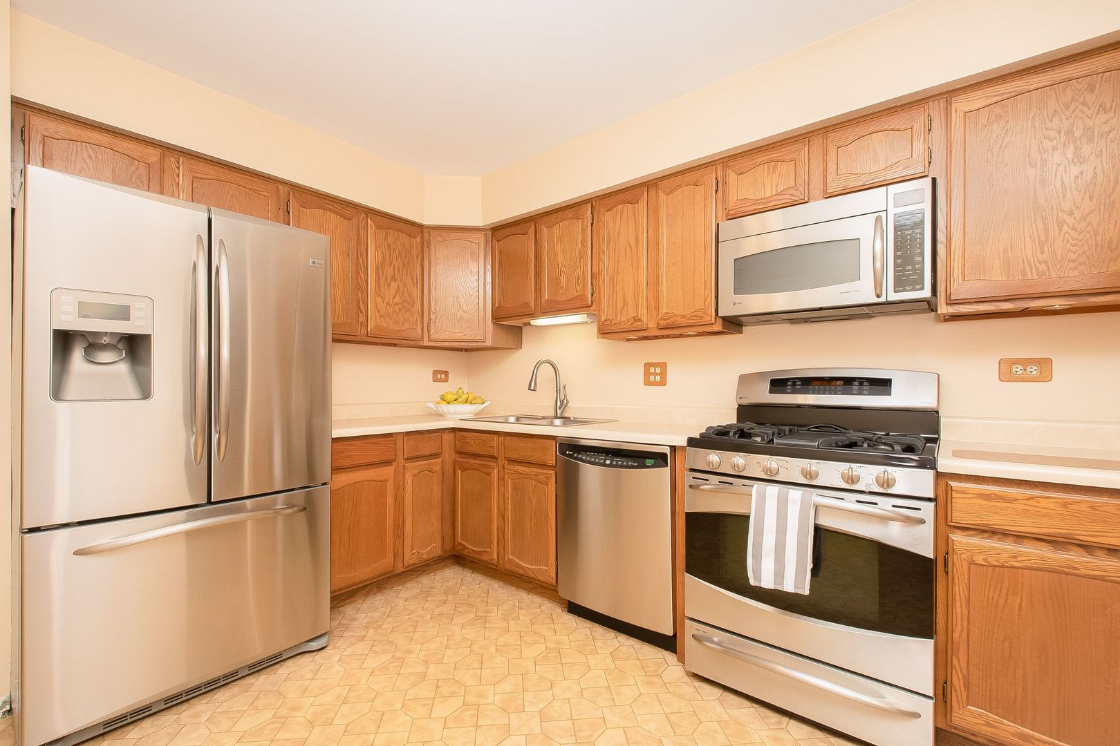 466 River Front Circle Naperville, IL 60540 - Photo 7 of 17 a kitchen with stainless steel appliances granite countertop a refrigerator sink stove and microwave