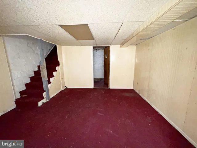 a view of an empty room with stairs and ventilation