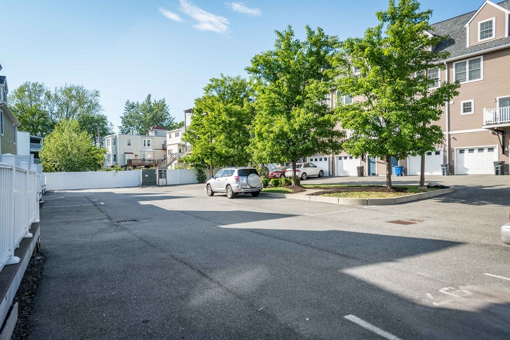 97 Boardman Street, Unit 97 Boston, MA 02128 - Photo 17 of 18 a building with trees in front of it