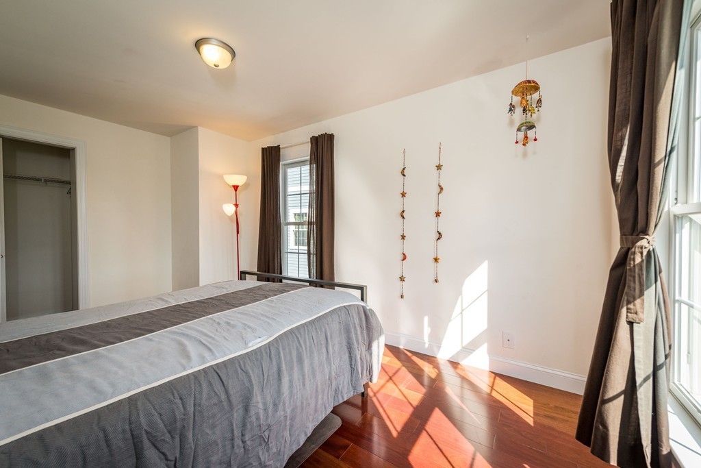 97 Boardman Street, Unit 97 Boston, MA 02128 - Photo 9 of 18 a bedroom with a bed and a window