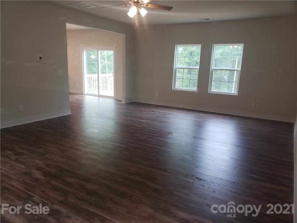 1806 Love Road Monroe, NC 28110 - Photo 4 of 20 an empty room with wooden floor and windows