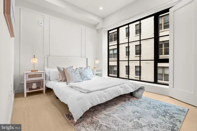 a bedroom with a large bed and a window