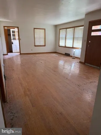 an empty room with windows and closet