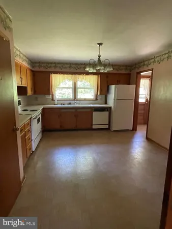 a large kitchen with stainless steel appliances a large window
