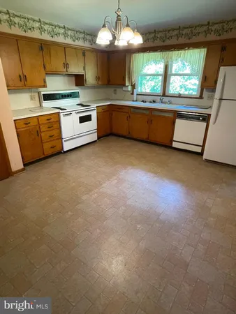 a kitchen with stainless steel appliances granite countertop a sink and cabinets