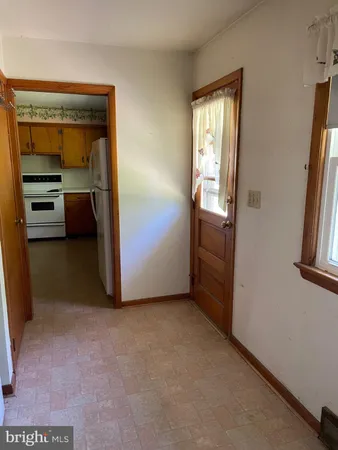 a view of empty room with a fireplace and cabinet