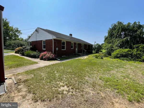 a view of house with yard and green space