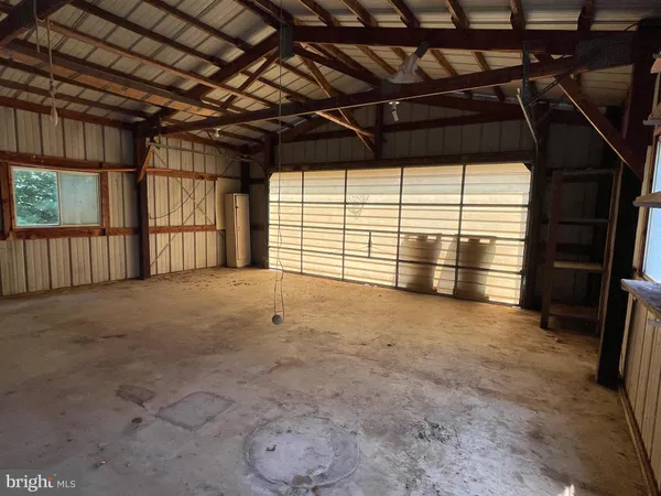 a view of empty room with wooden walls