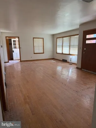 an empty room with windows and closet