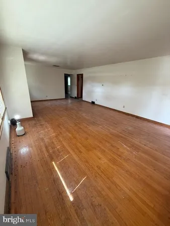 an empty room with wooden floor