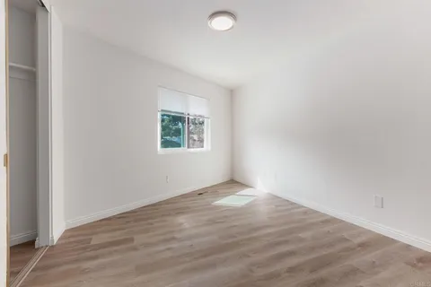 a bathroom with a granite countertop sink a toilet and mirror