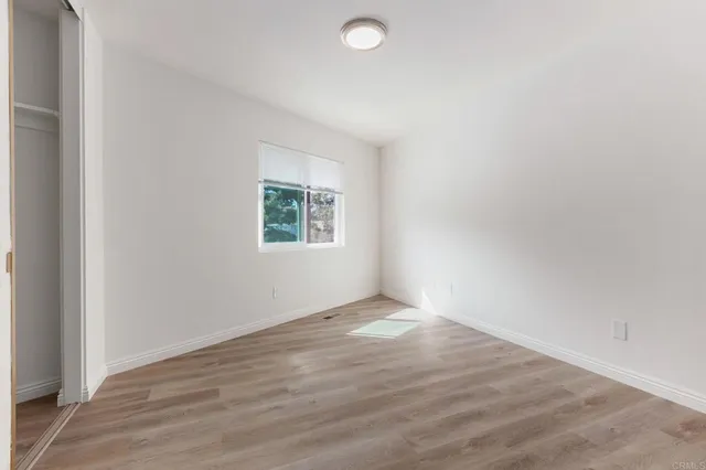 a bathroom with a granite countertop sink a toilet and mirror