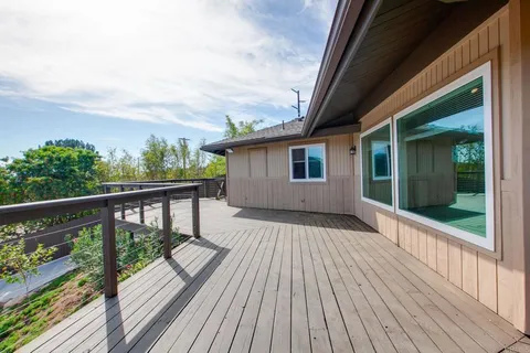 an aerial view of a house with a yard and trees