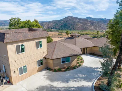 an aerial view of a house with garden space and a street view