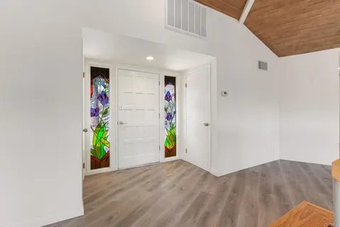 a view of an entryway with wooden floor
