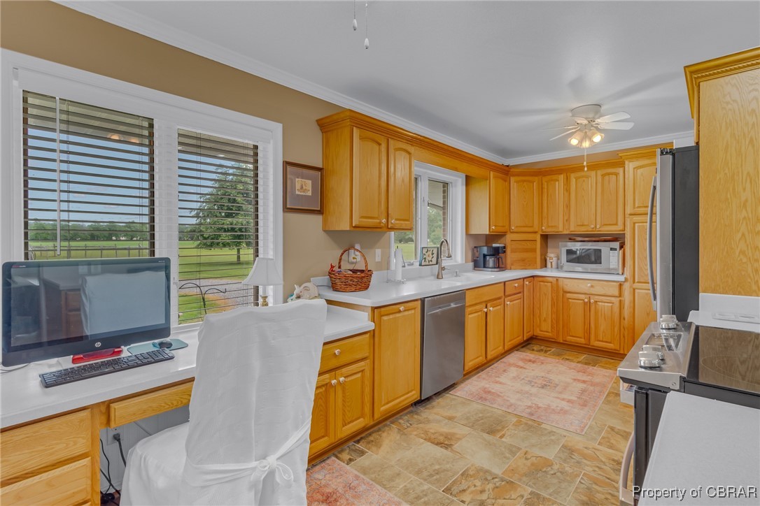 86 Greenfield Road Lancaster, VA 22503 - Photo 23 of 44 Kitchen with appliances with stainless steel finishes, ceiling fan, an office area, a sink, and light stone finish flooring