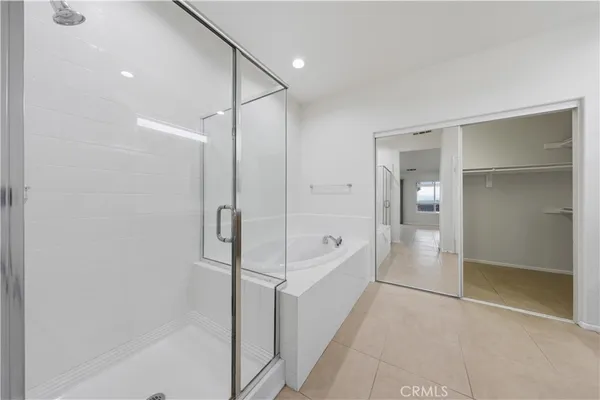 a bathroom with a shower and a glass door