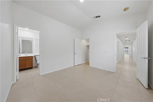 a view of an empty room and a bathroom
