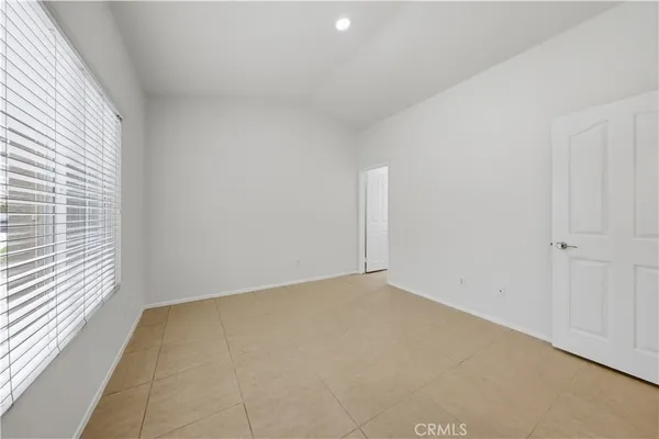 a view of an empty room and a window