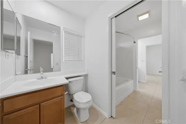 a bathroom with a double vanity sink toilet and shower