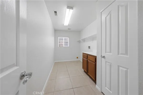 a view of a hallway with a washer and dryer