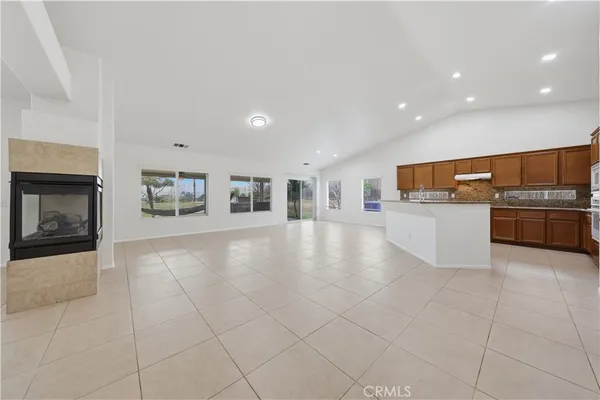 a view of kitchen with refrigerator and stove