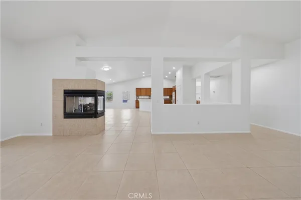 a view of an empty room with a kitchen