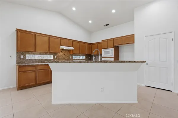 a kitchen with stainless steel appliances granite countertop a refrigerator sink and cabinets