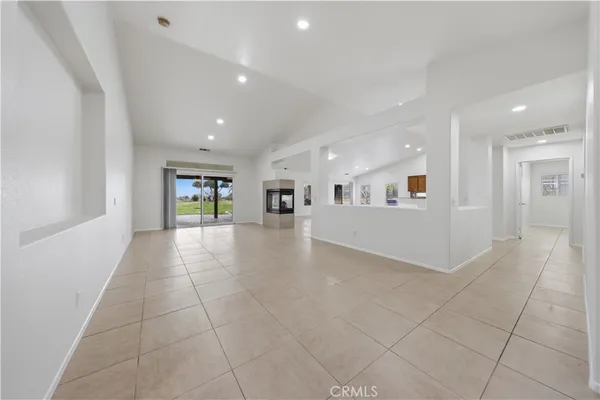 a view of a livingroom with furniture and floor to ceiling window