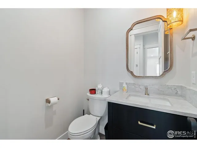 a bathroom with a sink vanity mirror and toilet