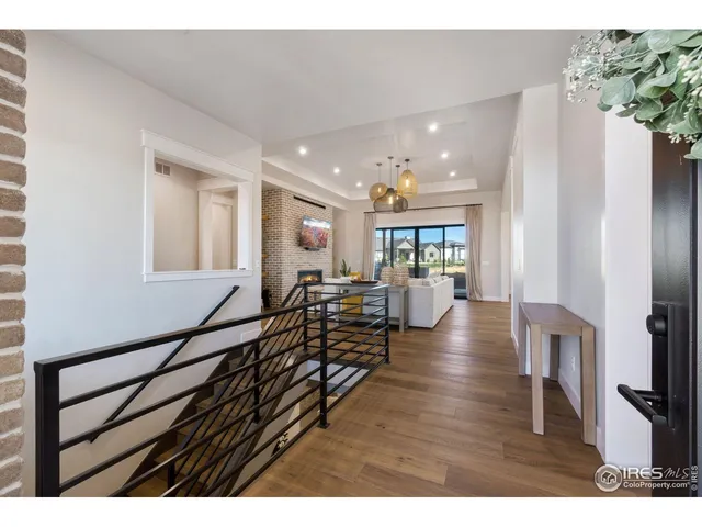 a living room with furniture wooden floor and a flat screen tv