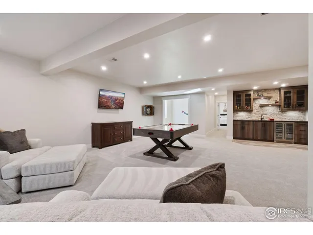 a living room with furniture and a dining table with kitchen view