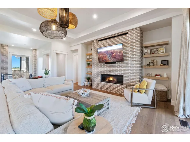 a living room with furniture a table and a fireplace