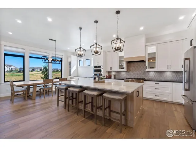 a large kitchen with a table and chairs