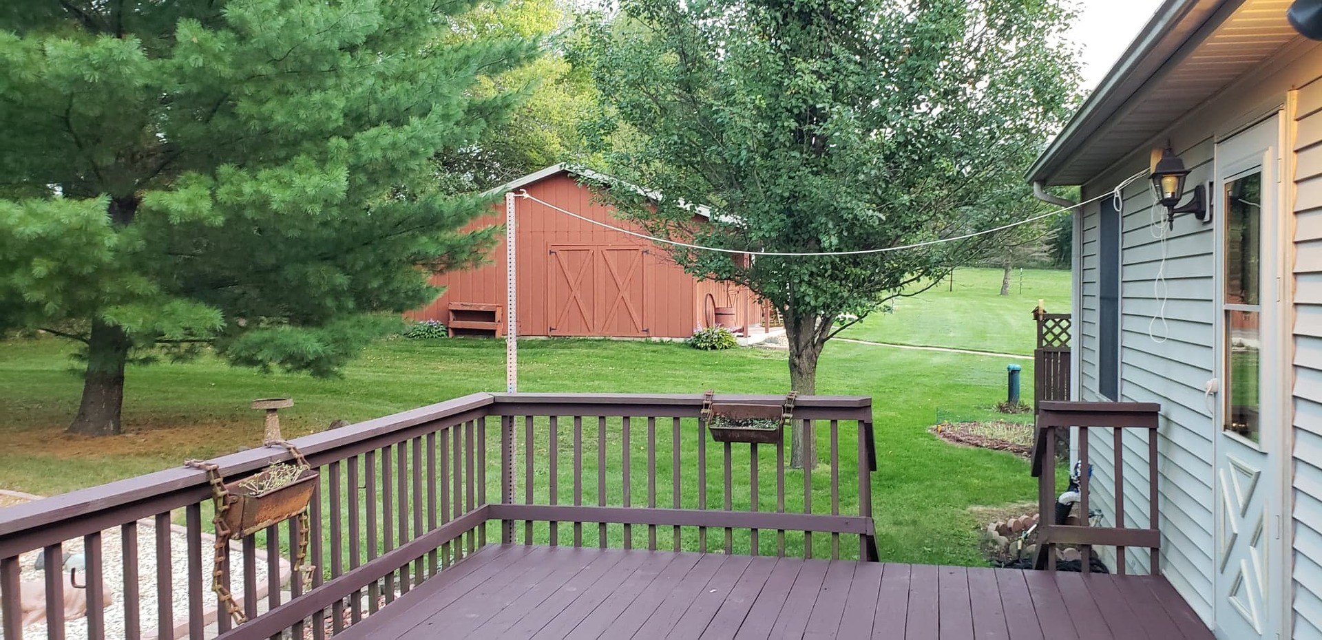 2018 Grand Detour Road Dixon, IL 61021 - Photo 15 of 25 a view of a deck with a floor to ceiling window and wooden fence