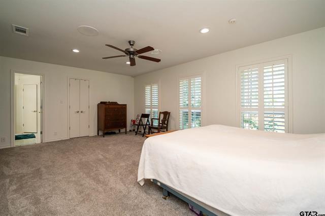431 Gifford Street Rusk, TX 75785 - Photo 32 of 40 a spacious bedroom with a bed and a chandelier