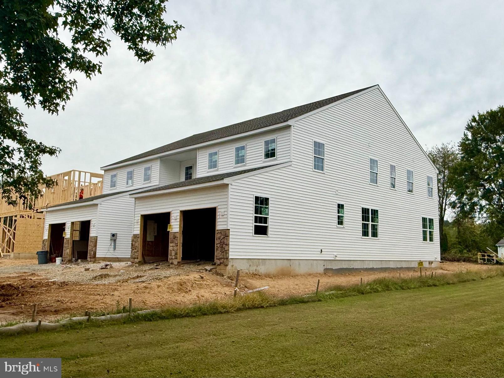 129 Stauffer Road Barto, PA 19504 - Photo 2 of 9 a view of a white house next to a yard with large trees
