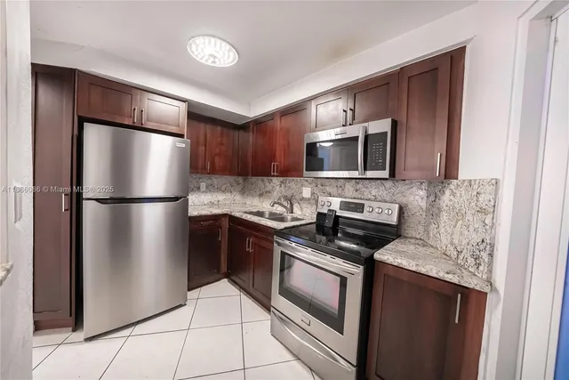 a kitchen with a refrigerator stove and microwave