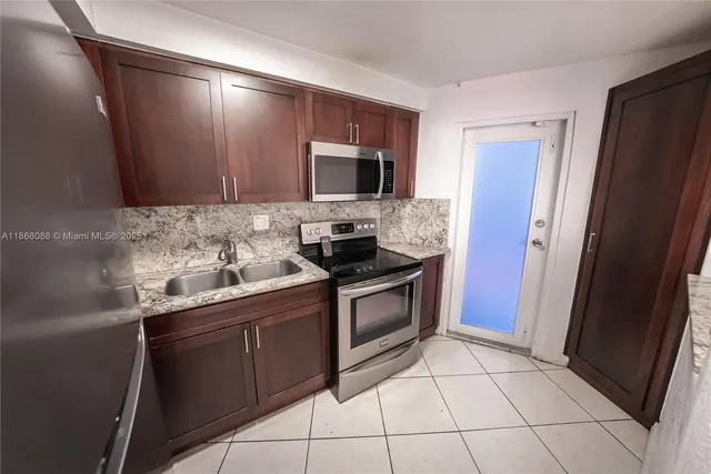 a kitchen with a sink stove and refrigerator