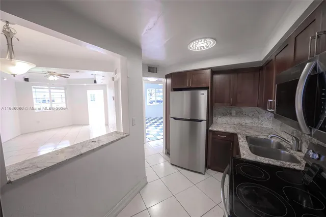 a kitchen with a refrigerator and a sink