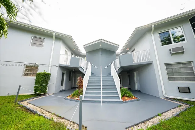 a view of an house with backyard and porch