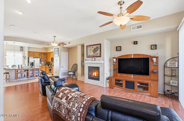 a living room with furniture a flat screen tv and a fireplace