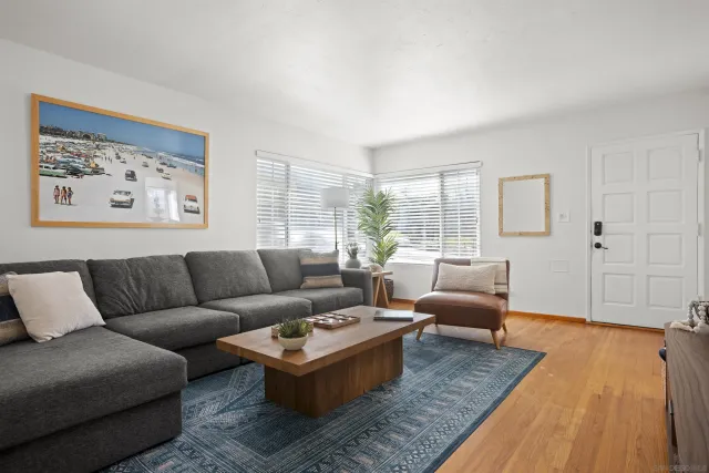 a living room with furniture wooden floor and window