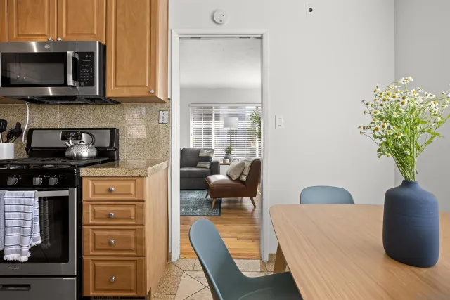 a kitchen with stainless steel appliances granite countertop a stove a microwave and cabinets