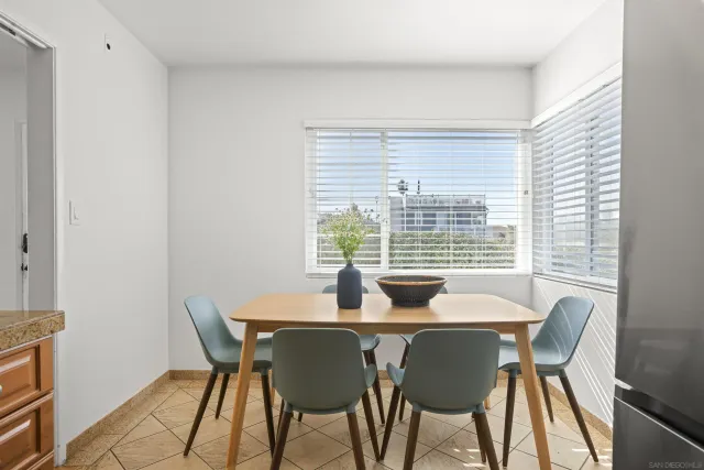 a dining room with furniture and window