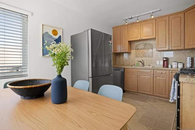 a kitchen with stainless steel appliances granite countertop a refrigerator and a sink