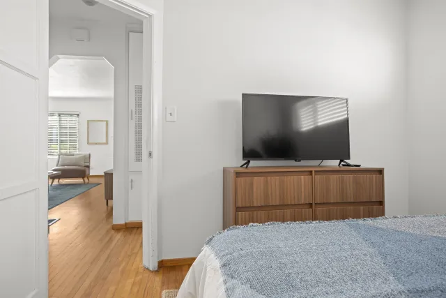 a bedroom with a bed and flat screen tv